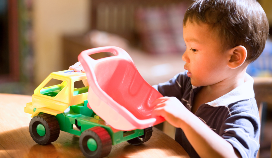 child playing with toy truck