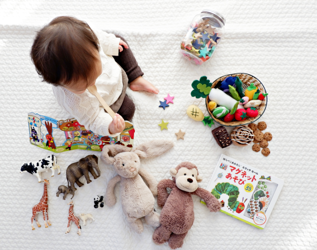 Child surrounded by toys