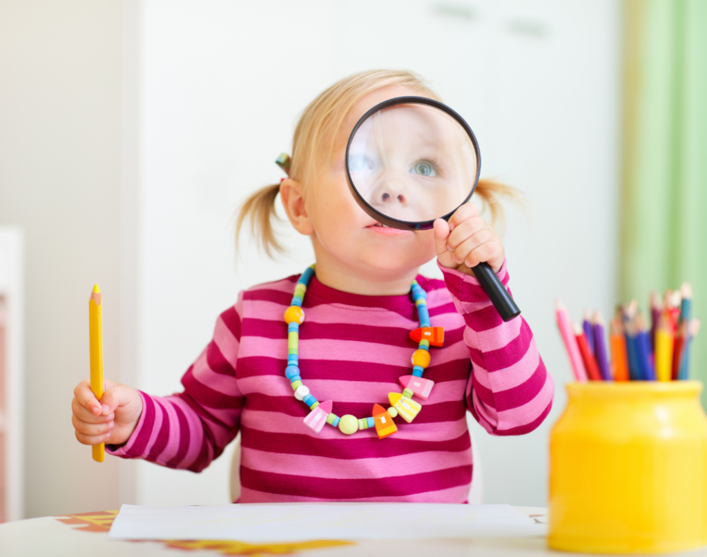 Child using magnifying glass to improve executive function