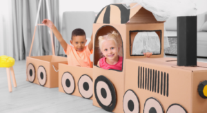 kids playing in cardboard box train