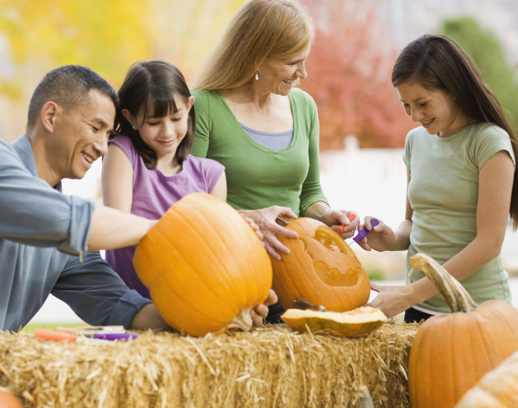 family carving pumpkins