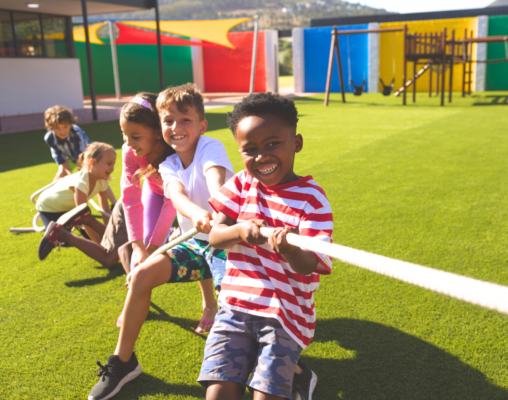 children participating in heavy work by playing tug of war