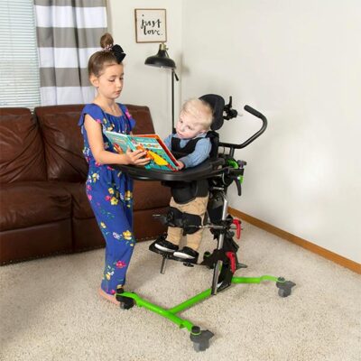 sister reading to brother in standing frame