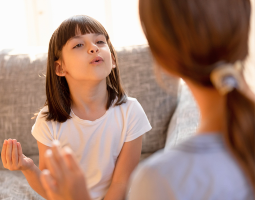 child working on stuttering with speech therapist
