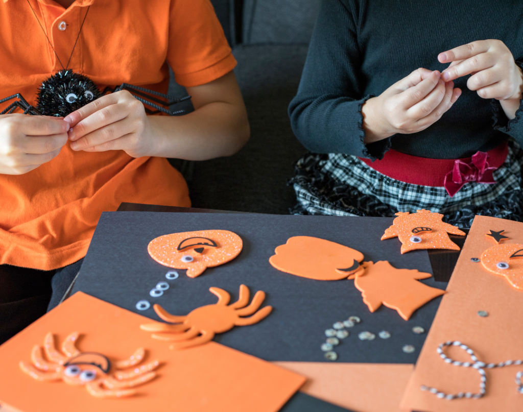 children practicing fine motor skills with Halloween crafts