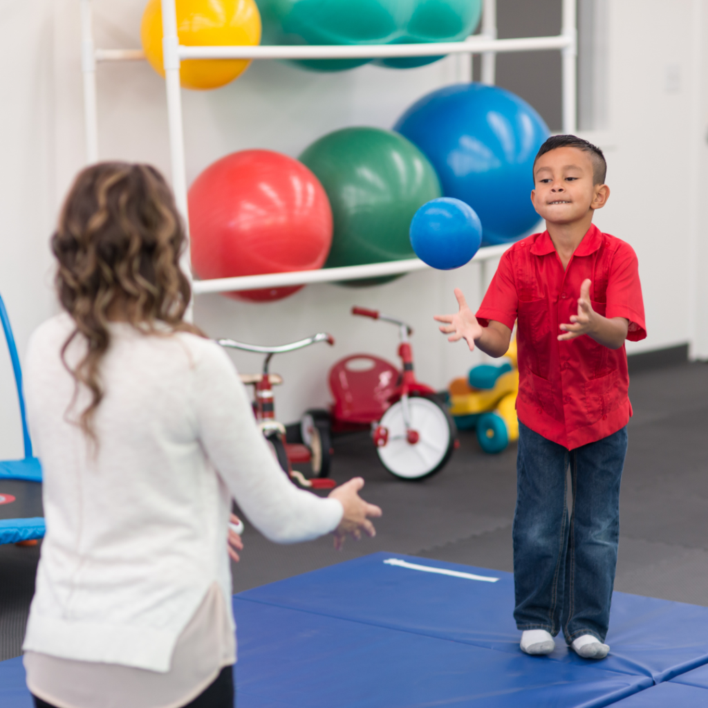 child catching ball in occupational therapy